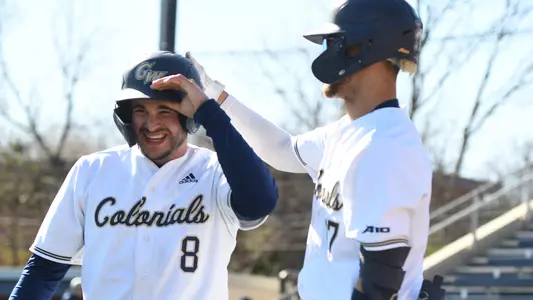 Cade Fergus and Mike Ludowig celebrate a run scoring