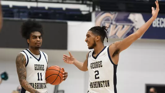 Brayon Freeman and James Bishop celebrate a 3OT victory vs. Duquesne