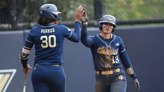 Sierra Lange high-fives Mia Parker vs. George Mason.