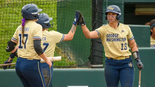 Sierra Lange high-fives Hannah Eslick in contest vs. Fordham.