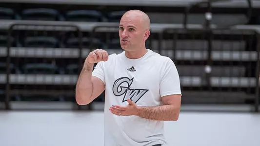 Chris Caputo coaches at a summer GW men's basketball workout.