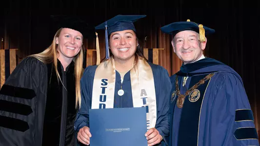 Alessandra Ponce poses with Head Coach Chrissy Schoonmaker and President Mark S. Wrighton at Athletics Commencement.