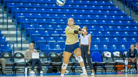 Bella Bowman digs the ball at Delaware