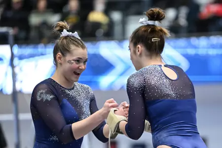 Marlee York and Deana Sheremeta fist bump at Lindsey Ferris Invitational