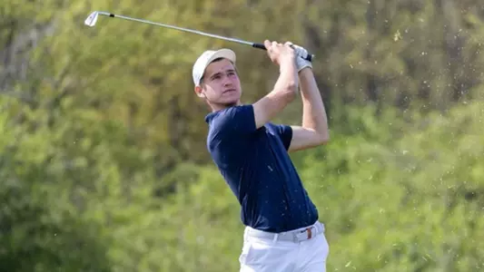 Adam Bencik swings the golf club