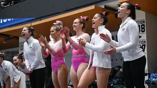 Gymnastics celebrates floor routine at Pink Meet