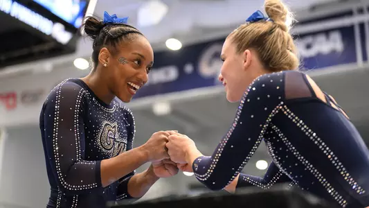 Kendall Whitman and Deja Chambliss fist bump before a routine