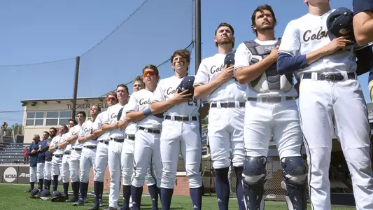 Baseball lines up on the field for the National Anthem