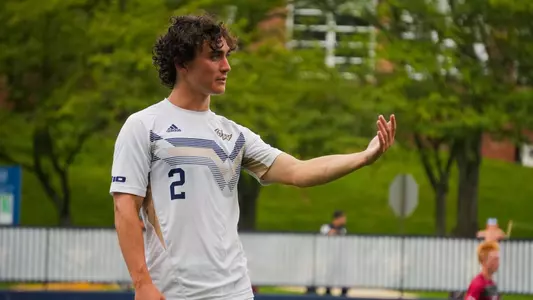 Will Turner motions to a teammate at the GW soccer field