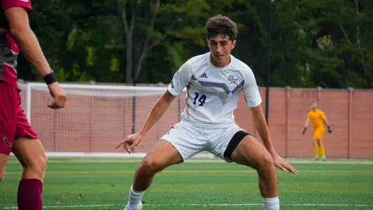 Michael Khan defends at the GW soccer field