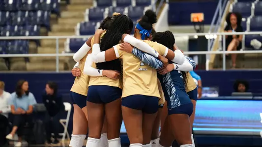 Volleyball huddles at Howard