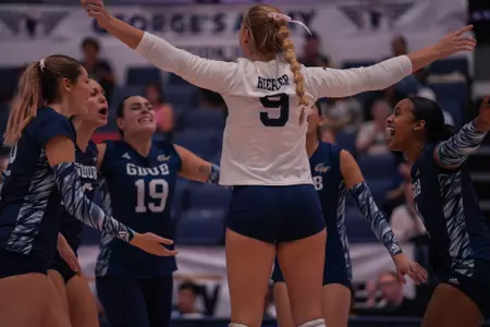 Volleyball celebrates a victory over Fordham