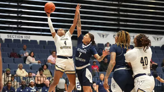 Sara Lewis attacking the rim as she drives past a Georgia Southern defender