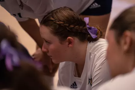 Maeve Loughran sits in the team huddle during a timeout