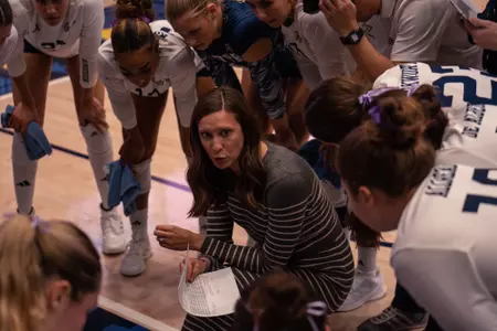 Katie Reifert talks to the Volleyball team during a timeout