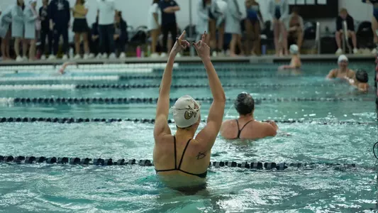 Women's swimming and diving celebrating event win at the Smith Center pool