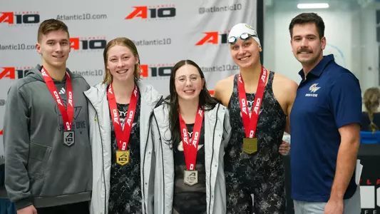 GW swimming and diving smiling with medals on Day 2 of A-10 Championships