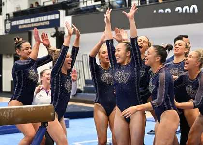 Maya Peters celebrates after her beam routine at Pride Meet