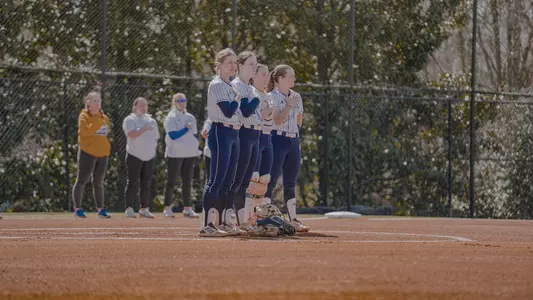 Softball Players standing for national anthem