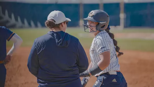 Ashley Corpuz smiling at the GW Softball Field