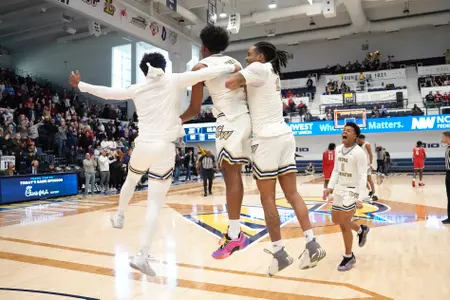 Players Celebrate Following Men's Basketball Win Over Dayton