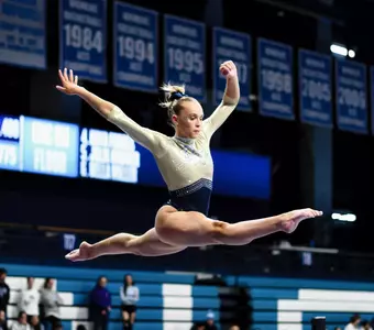 Lola Montevago performs on beam at UNC