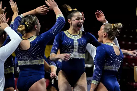 Nancy Kiner celebrates the end of her beam routine at UMD