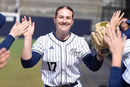Anna Reed getting high fives from her teammates before GW vs. Holy Cross