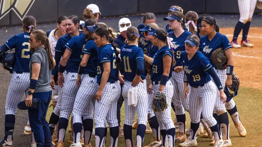 GW softball coming out of a team huddle