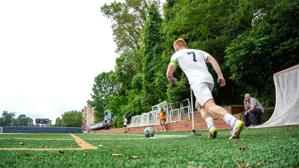 Alex Nicholson taking a corner kick at the GW Soccer Field