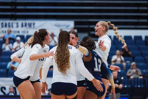 Volleyball huddles in the Smith Center against Loyola (MD)
