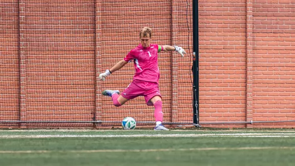 Tom Macauley kicking the ball on a goal kick