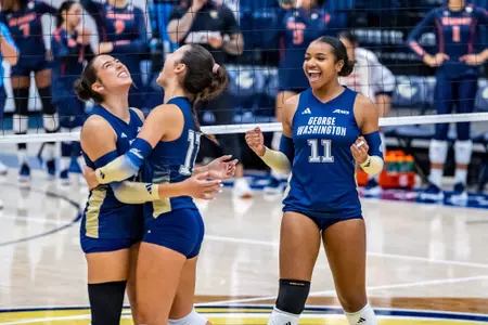 Riley Samuel, Cayla Cogan, and Tessa de Albergaria celebrate a kill vs. Morgan State