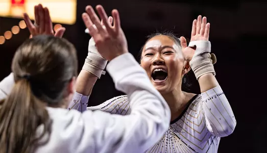 Alison Mun Celebrates her winning vault in the Terrapin Quad