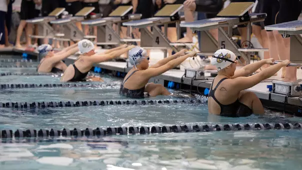 Women's swimming & diving on the starting blocks at Smith