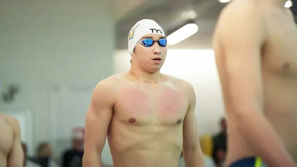 Daniel Choi standing on the pool deck ahead of a race