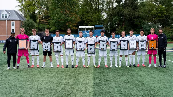 Men's Soccer seniors pose with senior posters