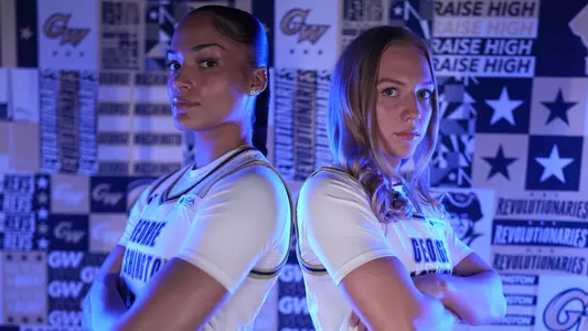 Gabby Reynolds and Anne Bair standing together in front of a GW backdrop