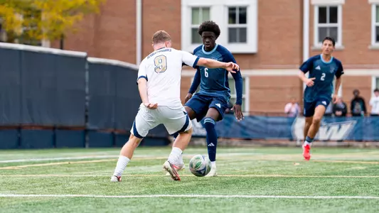 Joe Brayson dribbling at a Rhode Island defender