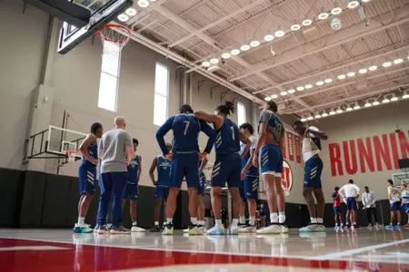 Men's basketball huddles at a practice at the University of Utah