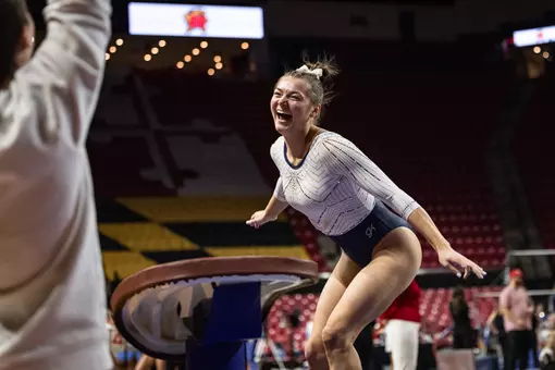 Deana Sheremeta celebrates a successful vault at Maryland