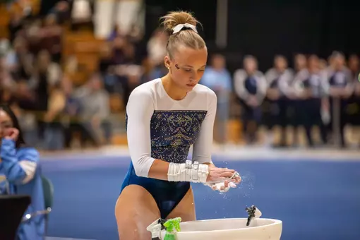 Lola Montevago prepares for bar routine at EAGL Championships