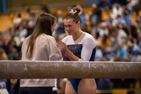 Deana Sheremeta prepares for beam routine at EAGL Championship with HC Steph Worrell