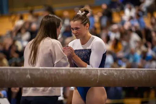 Deana Sheremeta prepares for beam routine at EAGL Championship with HC Steph Worrell
