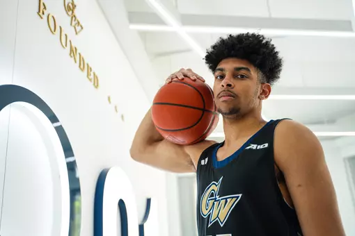 Felix Kossaras holds the basketball at a photoshoot