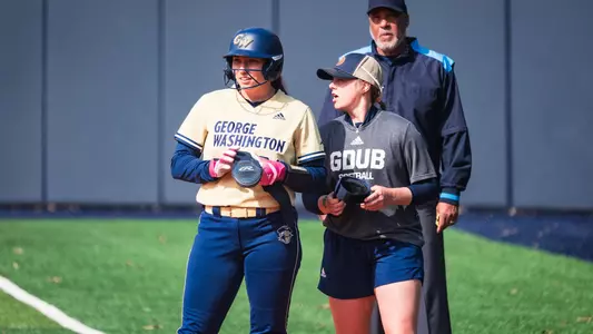 Emma Fales and Sam Bean talking at first base