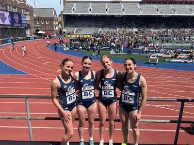 Women's DMR team poses at Penn Relays