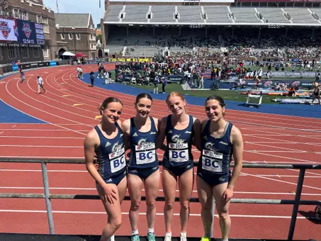 Women's DMR team poses at Penn Relays