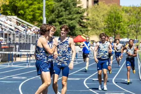 Men's Track huddles after racing