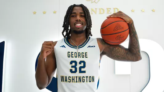 Malachi Arrington poses with a ball during a photoshoot